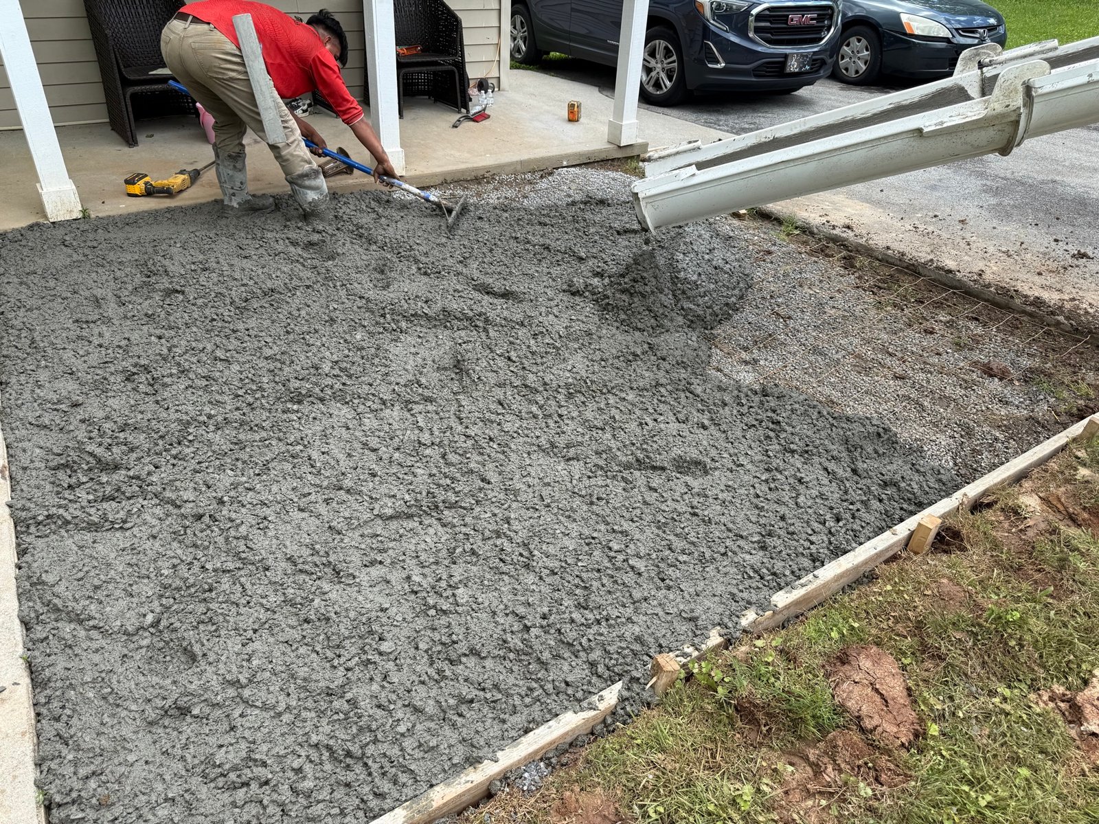 JSC crew member placing and raking wet concrete from the chute