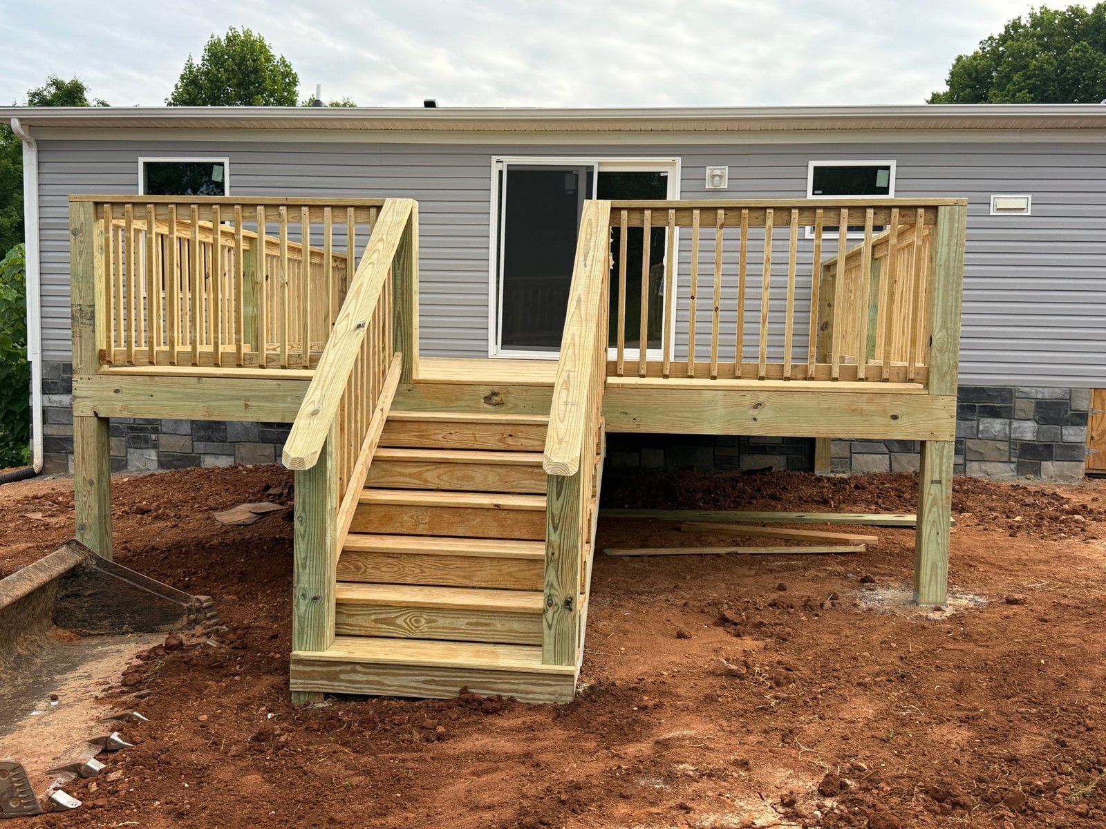 Finished pressure-treated deck with railing and stairs